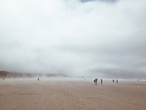 People on the beach in a misty day