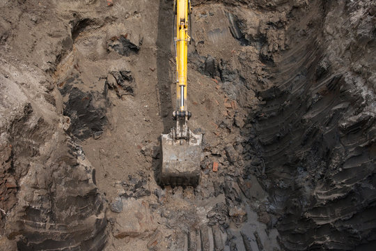 Top view of an excavator digging in the ground.