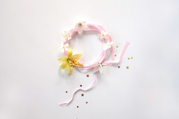 Round frame of pink ribbon with flowers and srars isolated on white background. Women`s day concept.