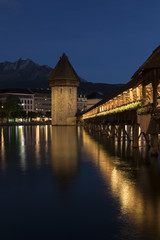 Lucerne with wooden bridge called chapel bridge by night