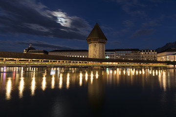 Fototapeta na wymiar Lucerne with wooden bridge called chapel bridge by night