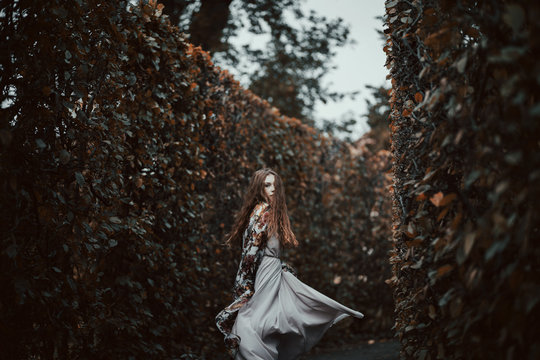 Artistic Portrait Of A Young Woman Running Through Maze