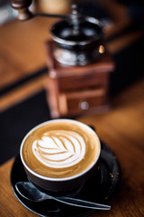 Old coffee grinder and coffee cup