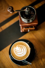 Old coffee grinder and coffee cup