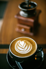Old coffee grinder and coffee cup