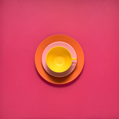 Dinner is served / Creative concept photo of kitchenware, painted plate with food on it on pink background.