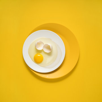 Dinner is served / Creative concept photo of kitchenware, painted plate with food on it on yellow background.