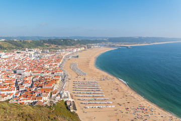 Fototapeta na wymiar Beach in Portugal in summer, people in holidays 