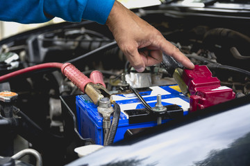 Hand of technician checking engine of car. Auto mechanic checking car engine. Maintenance checking car.