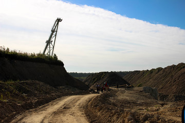 Giant excavator machinery industry. Big mine, develop mineral resources, excavator digs, cement in Lithuania