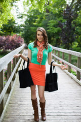 Beautiful Girl with Cloth Shopping Bags Walking on Wooden Bridge