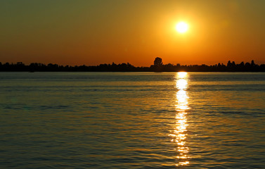 Yellow sun at the SUNSET with reflections on the water of the Ad