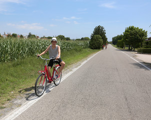 young cyclist riding bicycles on European roads in summer