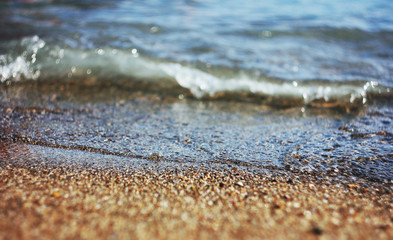 Sea, ocean waves with foam on the sand. Vacation at the beach
