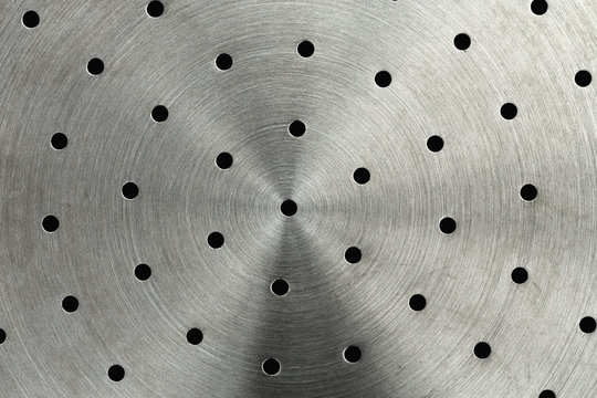 Close-up of the bottom of a stainless steel steamer basket