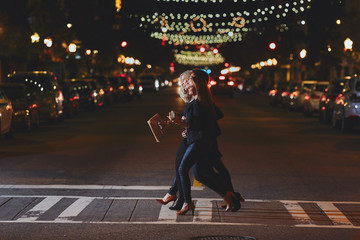 Cute women crossing the street at night