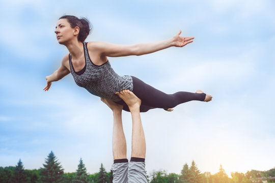 People practice acro yoga outdoors healthy lifestyle