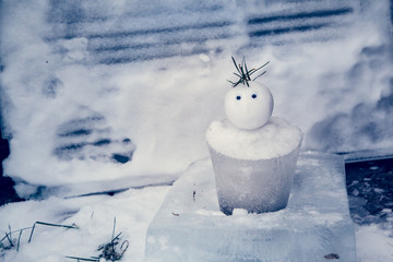 Tiny Snowman with an ice bucket for a body welcomes winter and has a surprised expression. Winter Fun!