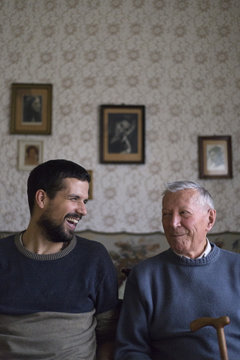 Adult grandson hugging his grandfather