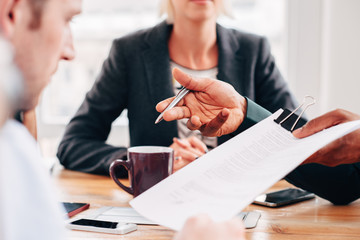 Close up businessman lawyer hands pointing to legal document for signing