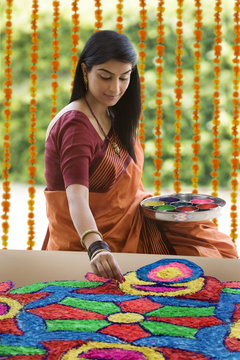 Woman making a rangoli 