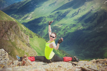 Obraz premium Happy Woman doing exercise on the top of mountain