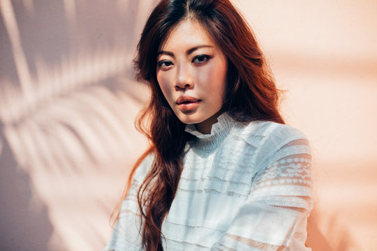 Beautiful Woman Against Pink Wall