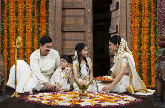 South Indian family with flower rangoli 