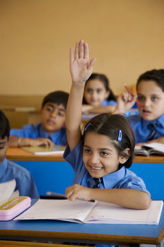 Girl raising hand in the classroom