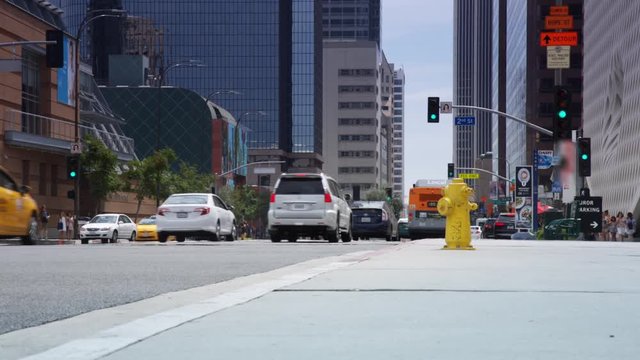 Downtown city traffic. Cars and busses make way towards the inner syline. A fire hydrant is accessible.