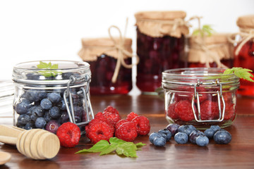 blueberries and raspberries in jars for the winter tea