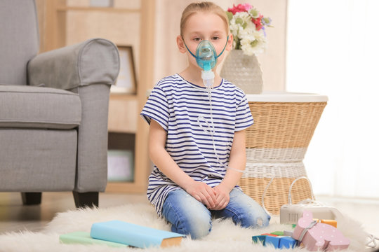 Girl using asthma machine at home