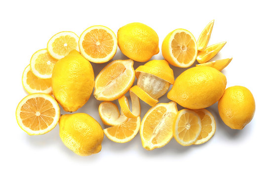 Delicious sliced and peeled lemons on white background