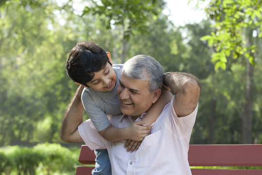 Grandfather and grandson enjoying in a park