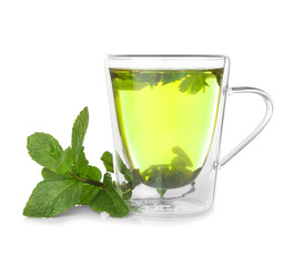 Cup of hot tasty tea with lemon balm on white background