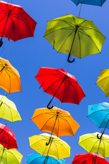 Suspended umbrellas swaying in the wind