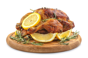 Wooden board with tasty homemade lemon chicken on white background