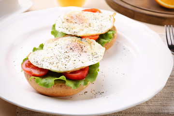 Plate with delicious egg sandwiches on table