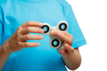 kid hand holding popular fidget spinner toy