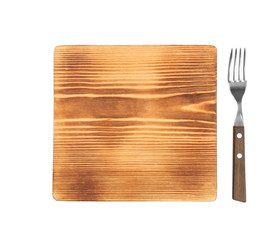 Wooden board and fork on white background
