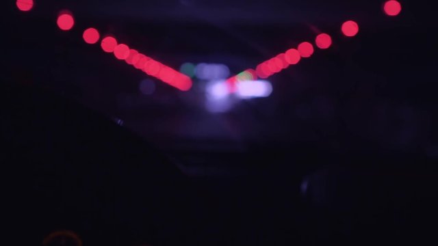 Night city lights. View from a mooving car. Slow Mo