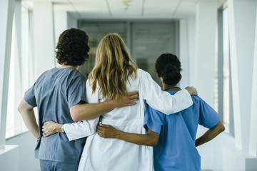 Doctor and nurses hugging