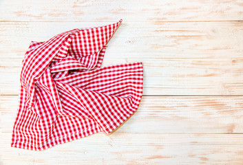 The checkered tablecloth on wooden table.