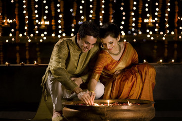 Couple lighting diyas 