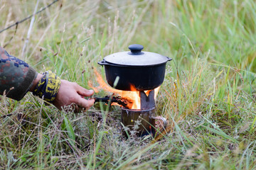 Cooking in the nature using a portable pyrolytic burner oven