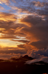 Sunrise on the top of Mount Adam Peak. Rising of the sun on Sri Pada - Sri Lanka. The mountain of butterflies. Background for poster.