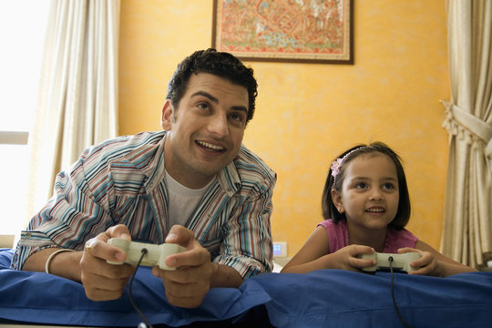Father and daughter playing video games 