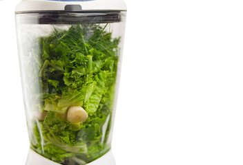 Preparing green smoothie in blender on white background