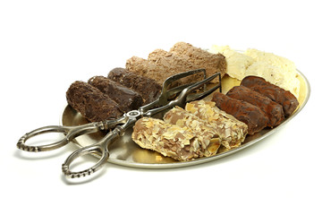 tray with handmade Belgian chocolate truffles and pastry tong isolated on white background