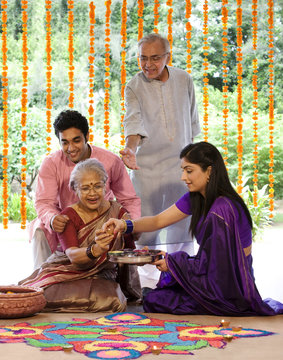 Family making a rangoli 